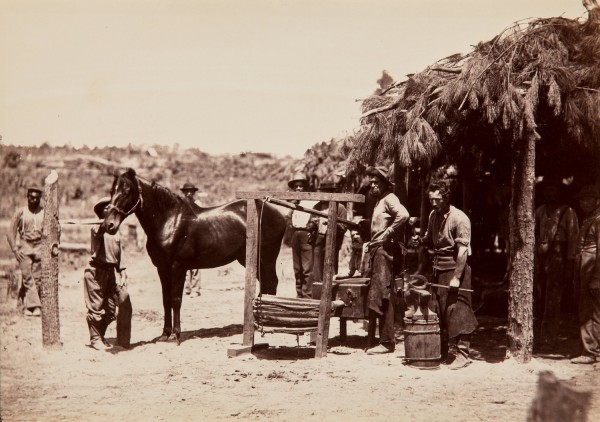 David Knox, Army Forge Scene, in Front of Petersburg, 1864/1865, albumen print from wet plate negative, On card mount, titled, dated, photographer and printer (A. Gardner) credits in letter press on mount recto. Ref.#16819.